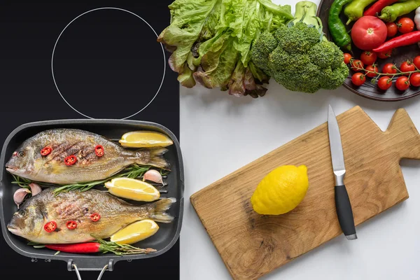 보드와 나이프와 신선한 야채와 그릴에서 생선의 — 스톡 사진