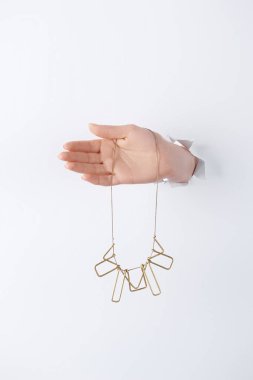 cropped image of woman holding hand with beautiful golden necklace through white paper clipart