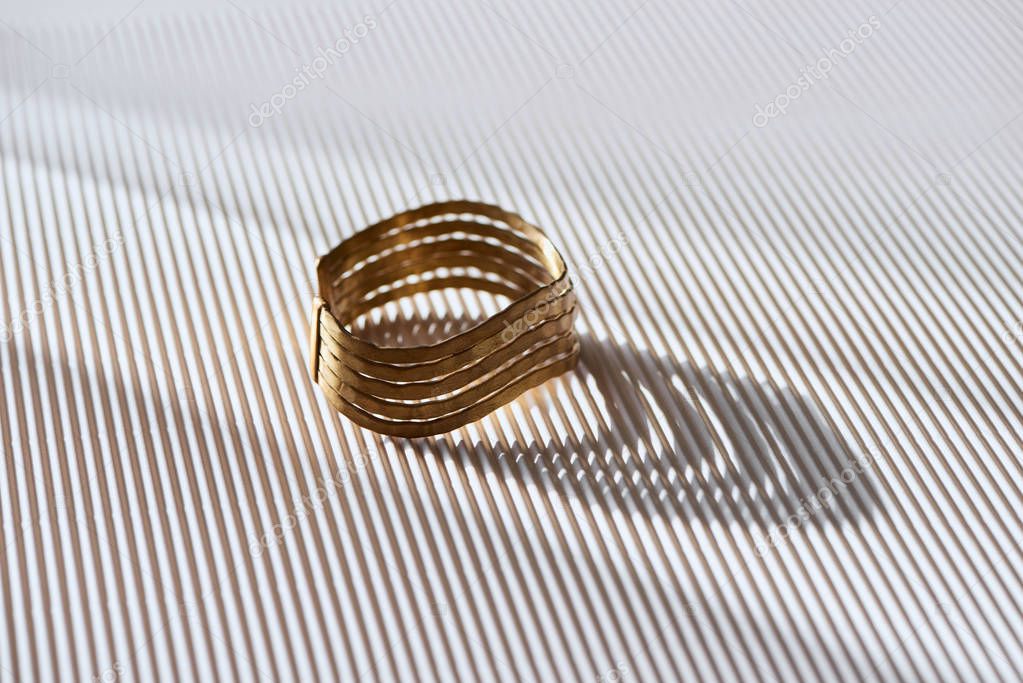 beautiful elegance ring on striped white surface with sunlight