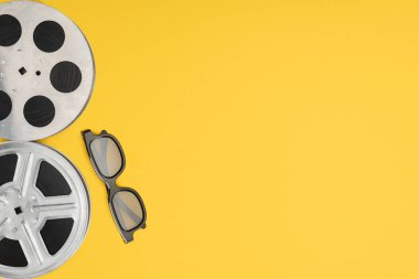 film reels and stereoscopic 3d glasses isolated on yellow