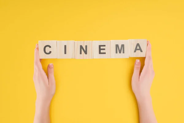 Top View Hands Holding Wooden Cubes Cinema Lettering Isolated Yellow — Stock Photo, Image
