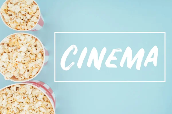 Top View Buckets Popcorn Vertical Row Cinema Lettering Isolated Blue — Stock Photo, Image