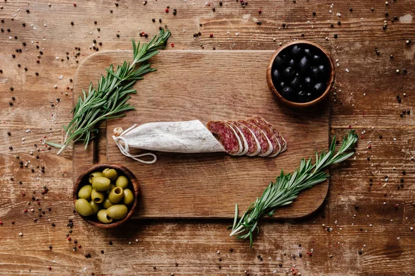 Top View Cutting Board Rosemary Black Green Olives Two Bowls — Stock Photo, Image