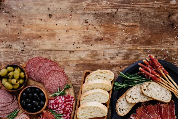 Top View Cutting Boards Olives Breadsticks Prosciutto Salami Bread Herbs — Stock Photo, Image