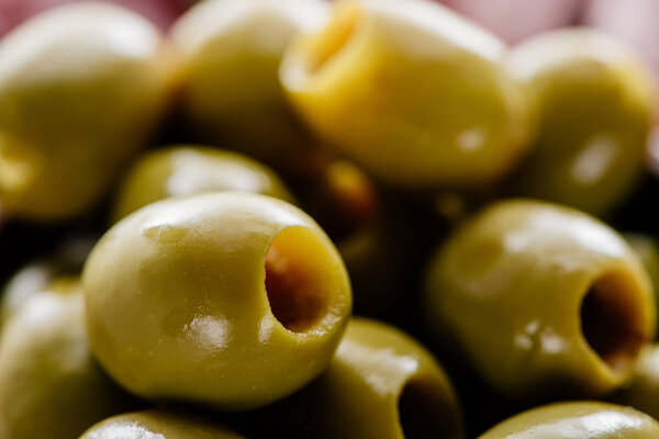 close up view of tasty green pitted olives