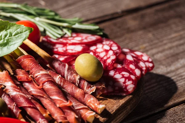Close View Cutting Board Delicious Sliced Salami Prosciutto Herbs Wooden — Stock Photo, Image