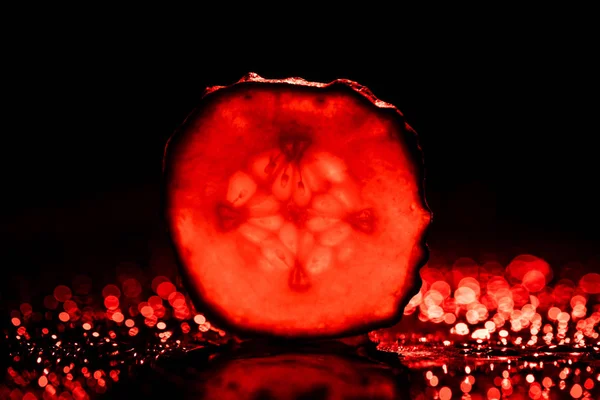 Slice Cucumber Neon Red Back Light Black Background — Stock Photo, Image