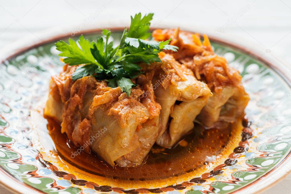 close up of traditional stuffed cabbage rolls on plate with ornament