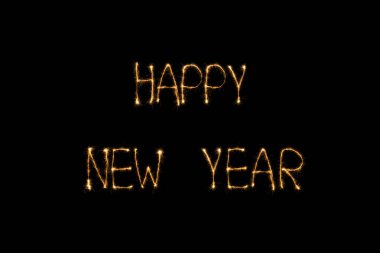close up view of happy new year light lettering on black backdrop clipart