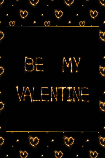 close up view of be my valentine light lettering and hearts on black background, st valentines day concept