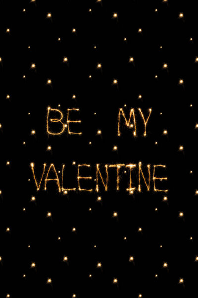 close up view of be my valentine light lettering on black background, st valentines day concept