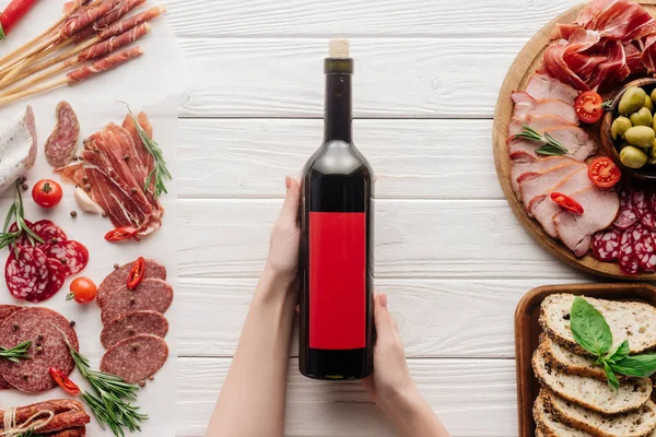 Partial View Woman Holding Bottle Red Wine White Tabletop Meat — Stock Photo, Image
