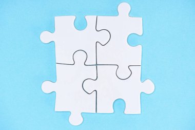 top view of arranged white puzzle elements on blue backdrop clipart