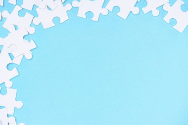 full frame of white puzzles arrangement on blue backdrop clipart