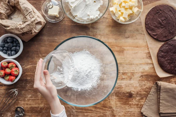 小麦粉をふるいにかけるとおいしい自家製ケーキの生地を準備する女性の部分のトップ ビュー — ストック写真