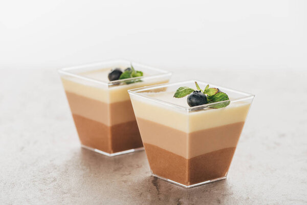 close-up view of delicious triple chocolate mousse desserts in glasses