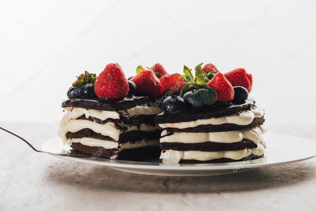 pieces of gourmet whoopie pie cake with fresh berries on white plate 
