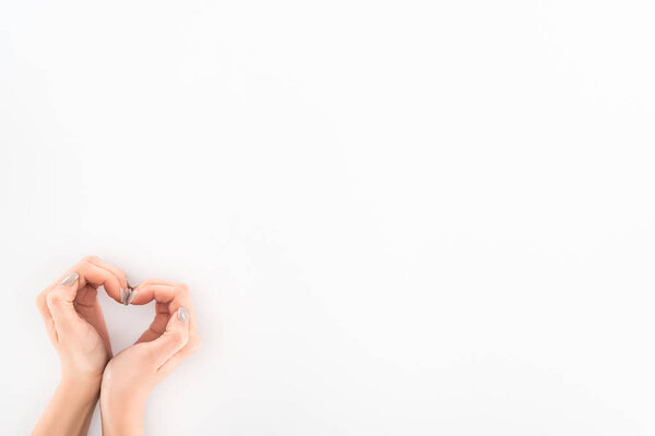 partial view of woman making heart symbol by hands, st valentine day concept 