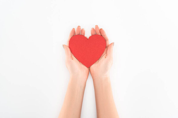 partial view of woman holding red heart symbol isolated on white, st valentine day concept