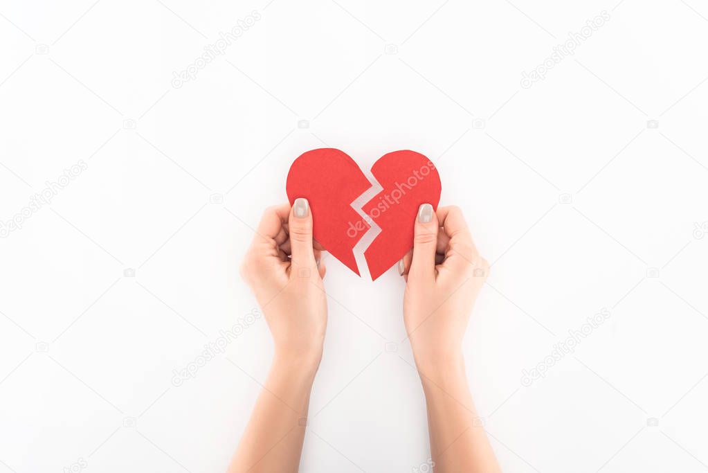 partial view of woman holding red broken heart symbol isolated on white, st valentine day concept