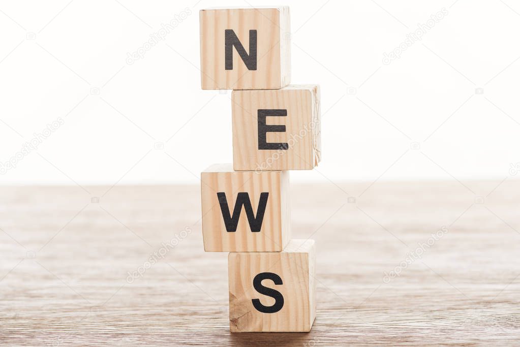 wooden cubes with word news on wooden tabletop