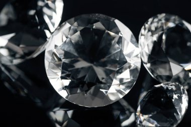 collection of pure shiny diamonds isolated on black clipart