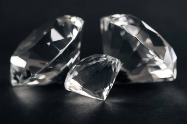 selective focus of clear diamonds on black background  clipart