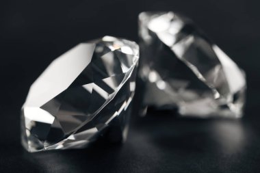 close up of two clear diamonds on black background  clipart