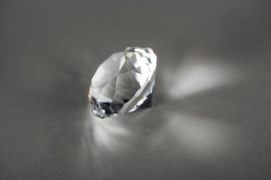shiny clear diamond on grey background clipart