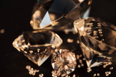 close up of pure golden diamonds isolated on black clipart