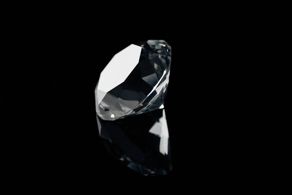 pure shiny diamond with reflection isolated on black