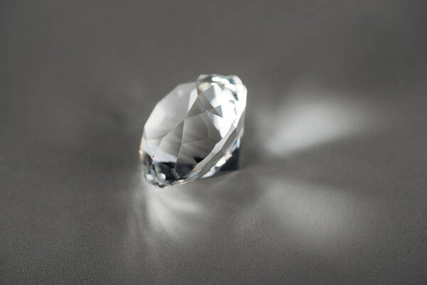 shiny clear diamond on grey background
