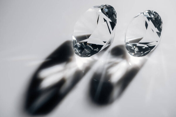 shiny clear diamonds with shadows on grey background