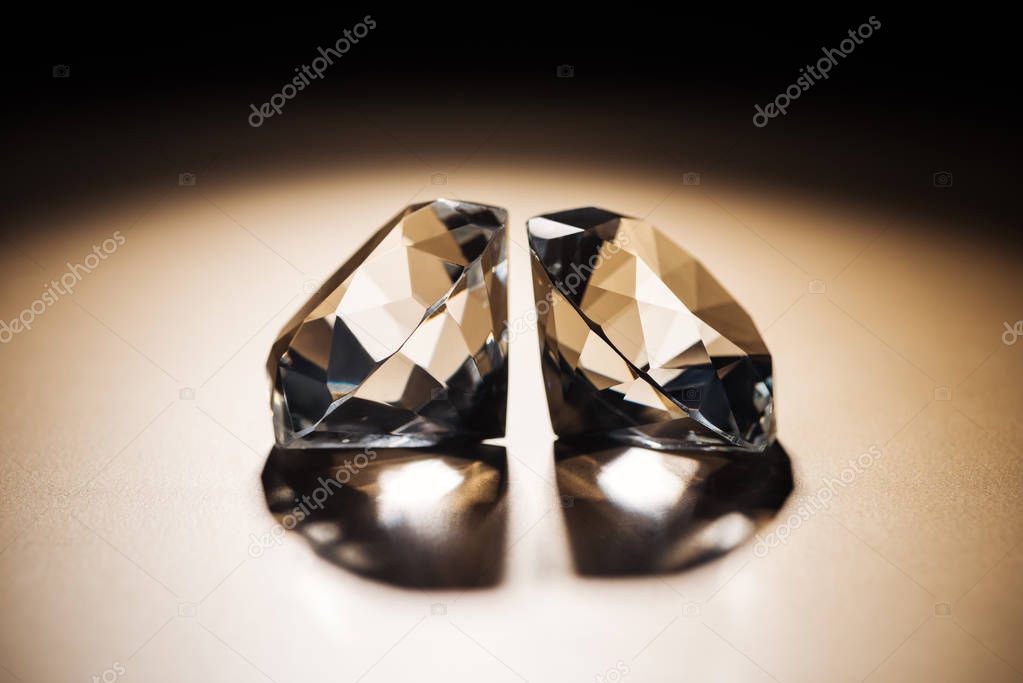 two clear big diamonds on black and golden background