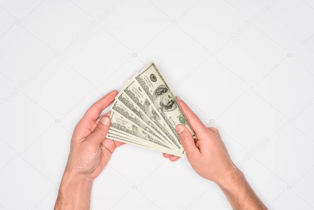 partial view of man holding money in hands isolated on grey