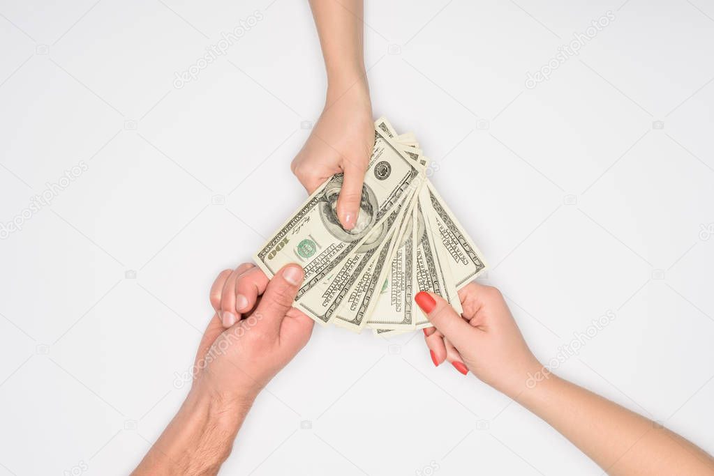 cropped view of people holding dollar banknotes isolated on grey