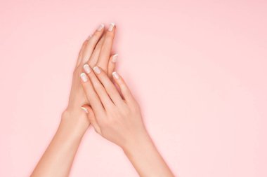 partial view of female hands isolated on pink with copy space