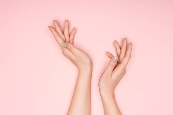 cropped view of female hands isolated on pink