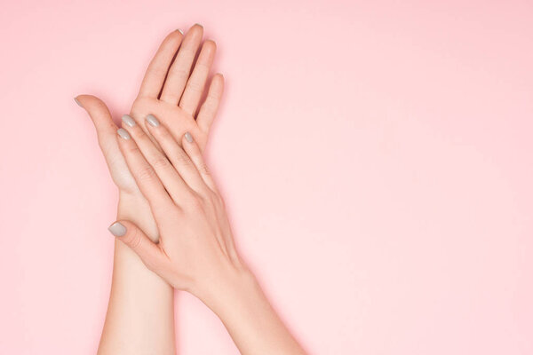 cropped view of female hands isolated on pink with copy space