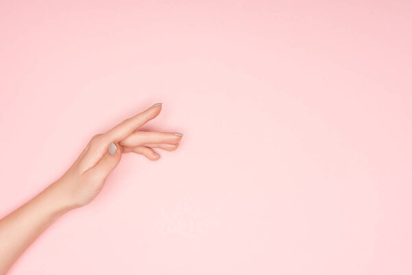 cropped view of female hand isolated on pink with copy space