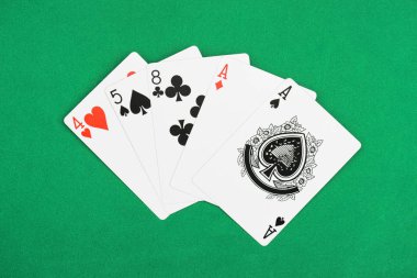 top view of green poker table and unfolded playing cards with different suits clipart