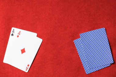güvertede kırmızı poker masası ve oyun kağıdı elmas takım elbise ile üstten görünüm