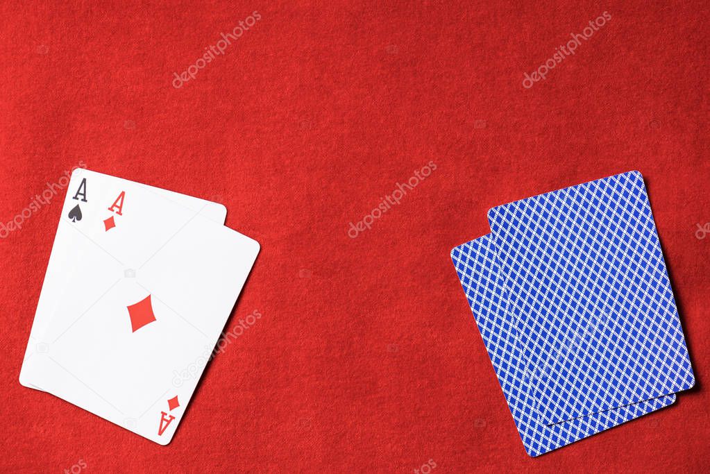 top view of red poker table and playing card with diamond suit on deck