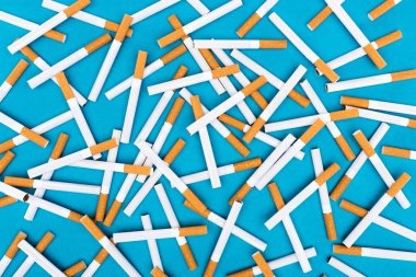 Studio shot of cigarettes isolated on blue  clipart
