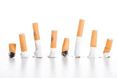 Studio shot of cigarette butts isolated on white, stop smoking concept clipart
