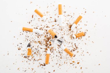 Studio shot of cigarette butts and tobacco isolated on white, stop smoking concept clipart
