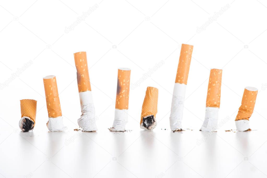 Studio shot of cigarette butts isolated on white, stop smoking concept