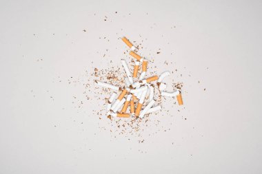 Top view of broken cigarettes isolated on grey, stop smoking concept clipart