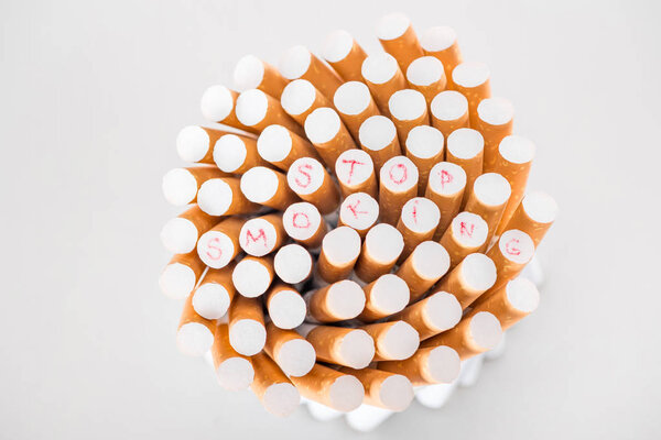 Top view of cigarettes isolated on grey, stop smoking concept