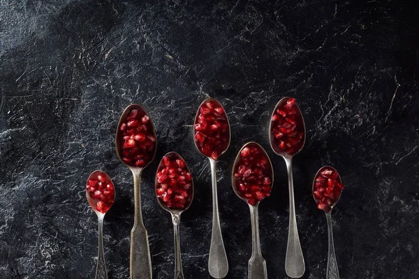 Flat Lay Garnet Seed Silver Spoons — Stock Photo, Image